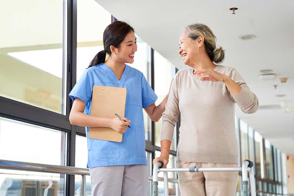 Older adult and family member reviewing care options together at a dining table in a residential setting.